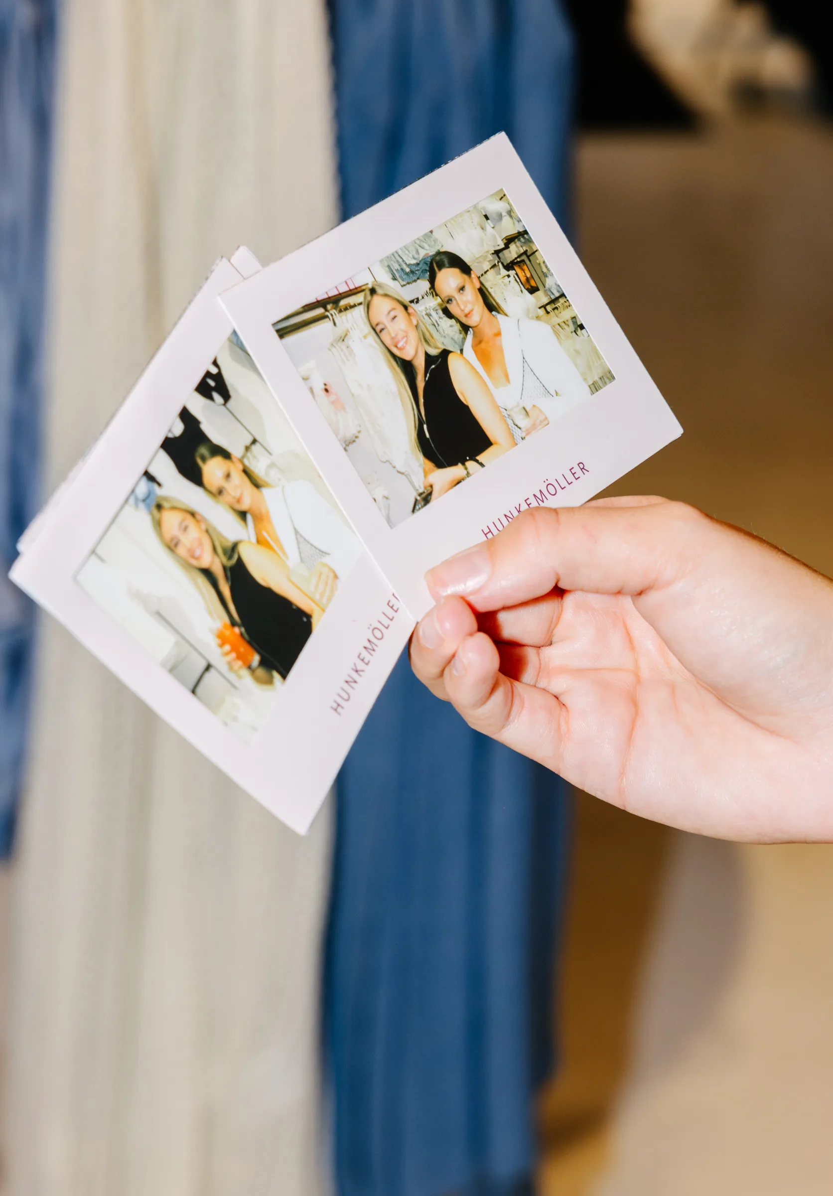 A hand holding personalised Hunkemöller instant photos